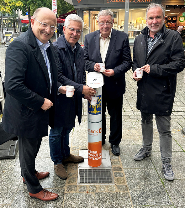 Ein Foto der offiziellen Inbetriebnahme des ersten Trinkwasserbrunnen in Hagen durch ENERVIE Vorstandssprecher Erik Höhne, Oberbürgermeister Erik O. Schulz, Ralf Quardt, Bezirksbürgermeister Hagen-Mitte und Thomas Köhler, Leiter des Umweltamtes